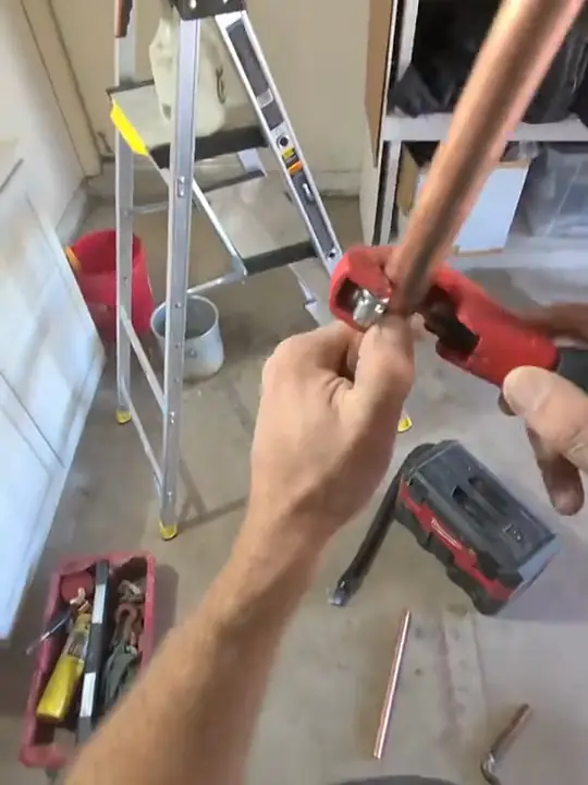 Through Jacob's glasses: a tubing cutter on copper pipe in a garage